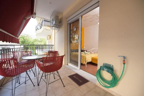 a balcony with a table and chairs and a hose at AMALFI luxury APARTMENT in Komotini
