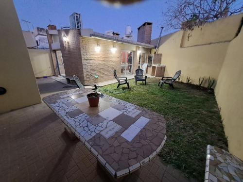 eine Terrasse mit einem Tisch und Stühlen im Hof in der Unterkunft Casa La Nona 5 personas con patio y quincho in Cordoba