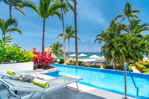 a pool at a resort with palm trees at Hyatt Ziva Puerto Vallarta in Puerto Vallarta