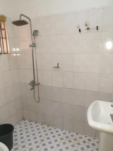 a bathroom with a shower and a sink at Vee female hostel in Wupa