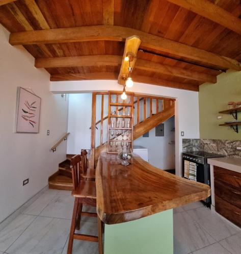 a kitchen with a wooden counter top and wooden ceilings at Villas Flakis, Luna in Monteverde Costa Rica