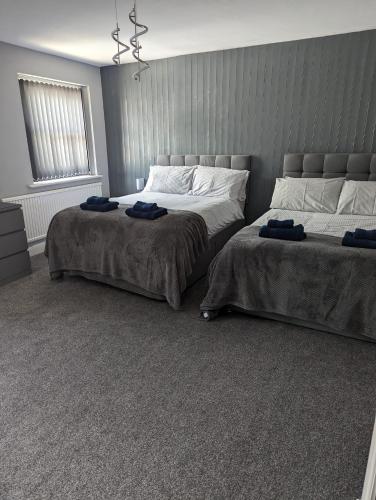a bedroom with two beds with towels on them at Kings Head in Chepstow