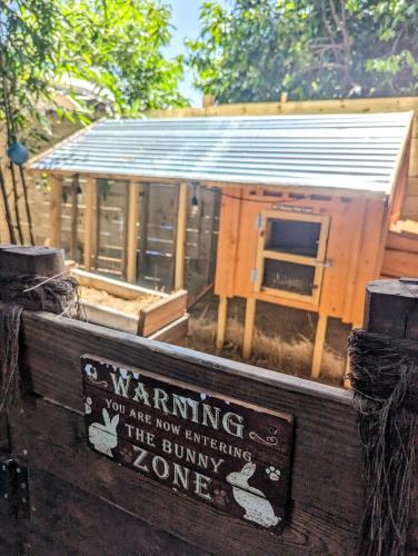 a sign that sayswarning you are now entering the bunny pound at Cozy AF Tiny-House Oasis in Tampa