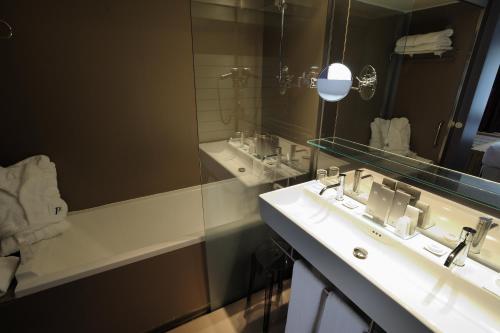 a bathroom with a sink and a mirror at Hotel Continental Balneario de Panticosa in Panticosa