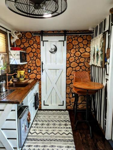 a kitchen with a white door and a table at Cozy AF Tiny-House Oasis in Tampa