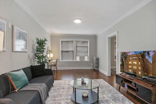 a living room with a couch and a tv at 1BR Serene and Cozy Chicago Apartment - Manor 2 in Chicago