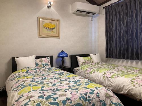 a bedroom with two beds and a window at Villa Ashitani - Vacation STAY 08864v in Nantan city