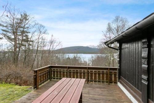 a wooden deck with a view of a lake at Fjord peace in Skodje