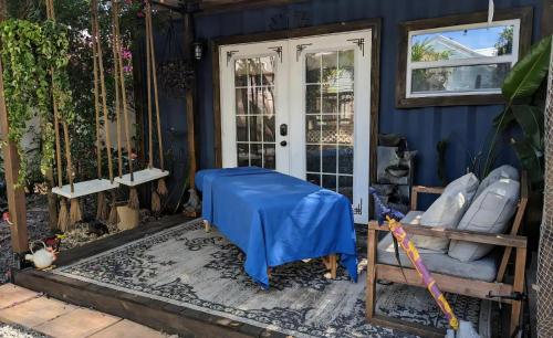 a blue house with a blue sheet on the front door at Cozy AF Tiny-House Oasis in Tampa