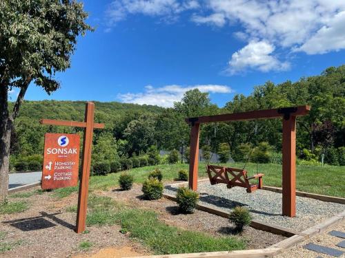 a park with two benches and a wooden cross at Sonsak - Unit 4 in Charlottesville