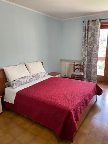 A bed or beds in a room at La Fiorita Aosta