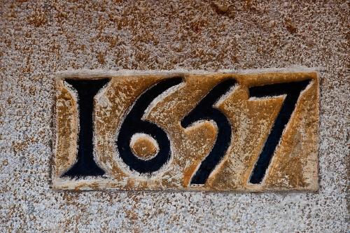 a metal number on the floor with the number at Hôtel Ithurria - Teritoria in Aïnhoa