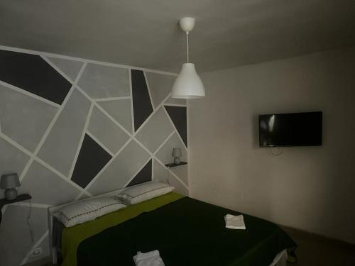 a bedroom with a black and white geometric wall at Il cortiletto Haus in Catania