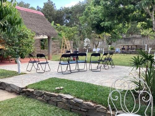 a group of chairs and a table in a yard at Villa ChezSoa, Antananarivo in Antananarivo