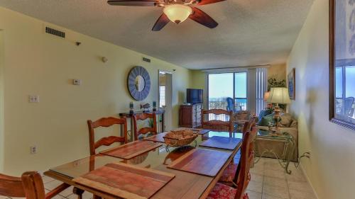 a dining room with a table and chairs and a clock at Destin on the Gulf 302 - Perfect location for a nice family getaway in Destin