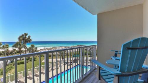 a blue chair sitting on a balcony with a view of the beach at Destin on the Gulf 302 - Perfect location for a nice family getaway in Destin