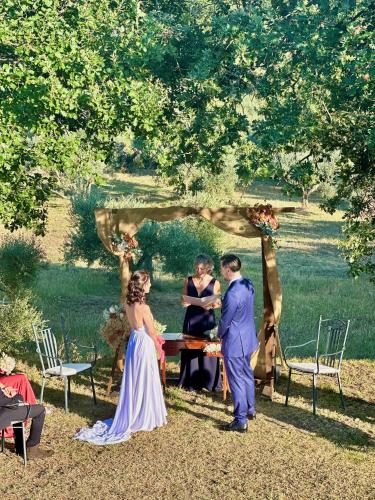 a group of people standing around a table at a wedding at LaChiusa Tuscany in Montefollonico