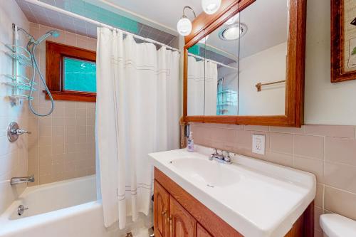 a bathroom with a sink and a tub and a shower at Robin's Perch in West Townshend