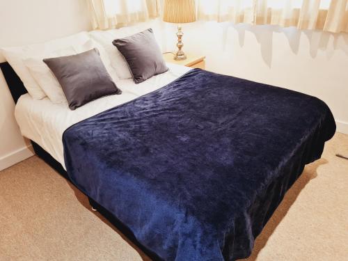 a bedroom with a large bed with a blue blanket at Fabulous one bedroom Apartment Sheffield City Centre in Sheffield