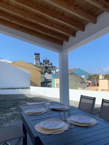 a blue table with plates of food on a patio at Casa do Porto, relax with this stunning sea view in Porto Formoso