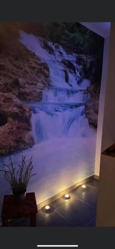 a mural of a waterfall on a wall with lights at Penzion Loket in Loket