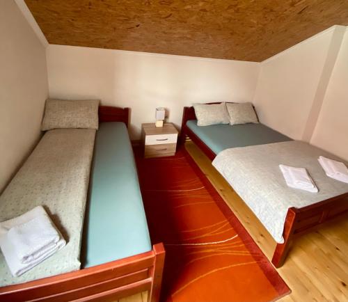 two bunk beds in a small room with a wooden floor at Apartments Bozovic in Žabljak