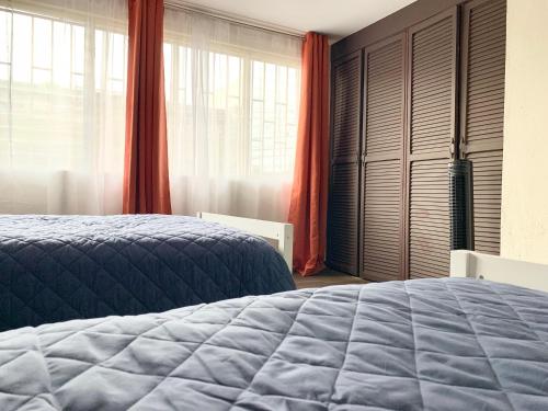 a bedroom with a bed and a large window at Cata Bed Breakfast Pet-friendly in San José