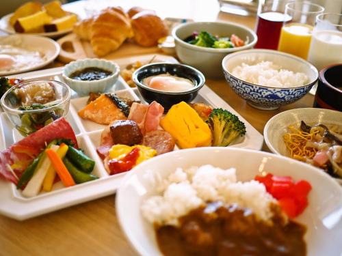 佐世保市にあるSunwest Hotel Sasebo - Vacation STAY 22075vの食べ物の皿やボウルが置かれたテーブル