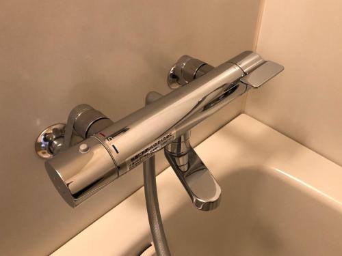 a metal towel bar attached to a toilet in a bathroom at Sunwest Hotel Sasebo - Vacation STAY 22133v in Sasebo