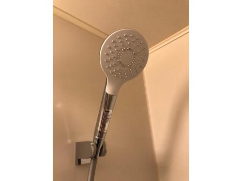 a shower head is attached to a wall at Sunwest Hotel Sasebo - Vacation STAY 22133v in Sasebo