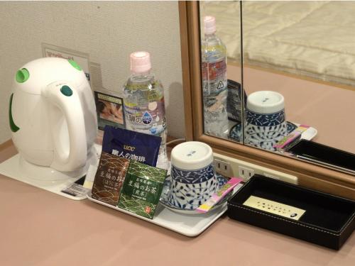a shelf with bottles of water and a mirror at Sunwest Hotel Sasebo - Vacation STAY 22136v in Sasebo