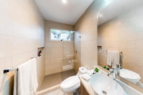 a bathroom with a sink and a toilet and a tub at Ciudad del Mar 104 in Jacó