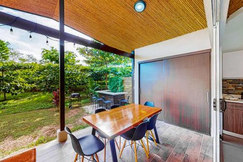 a dining room with a table and chairs on a patio at Ciudad del Mar 104 in Jacó