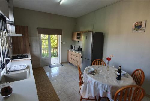 a kitchen with a table and a kitchen with a refrigerator at Chez Diana in Flic-en-Flac