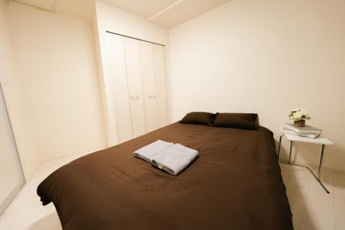 a bedroom with a bed with a towel on it at FL Rejidence Shinjuku 2 - Vacation STAY 15200 in Tokyo