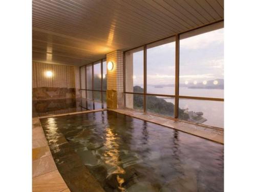 a house with a pool with a view of the ocean at Wano Resort Hazu - Vacation STAY 25560v in Gamagōri