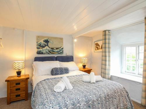 En eller flere senge i et værelse på Dormouse Cottage