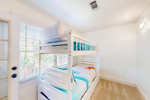 a white bunk bed in a white room with a window at Three Kings in Demere Park