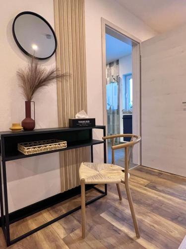 a dressing room with a chair and a mirror at Große Wohnung Wellness + Sauna + Netflix in Petershagen