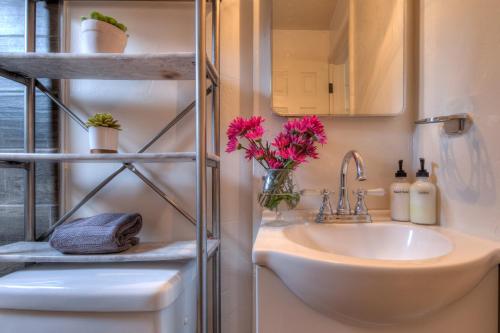 a bathroom with a sink and a mirror at Desert Gardens #3 in Moab