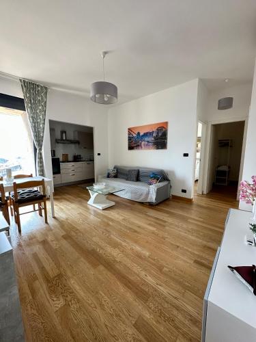 a large white room with a bed and a living room at Due Passi dal Porto in Genova