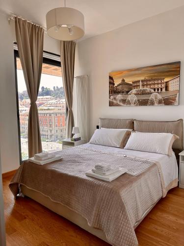 a bedroom with a large bed and a large window at Due Passi dal Porto in Genoa
