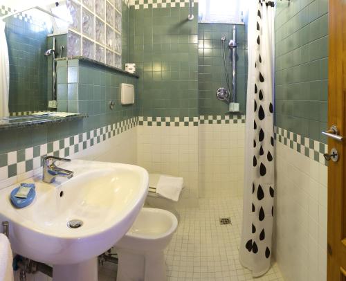 a bathroom with a sink and a toilet at Zina Suite Apartment in Giardini Naxos