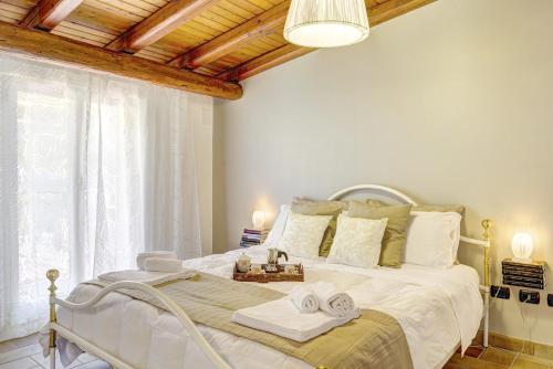 a bedroom with a white bed with towels on it at Zina Suite Apartment in Giardini Naxos