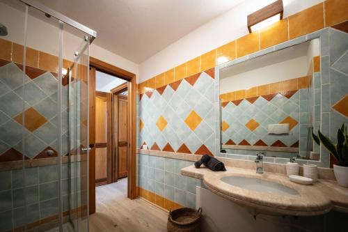 a bathroom with a sink and a shower at Sweet Life in Golf Is Molas in Pula