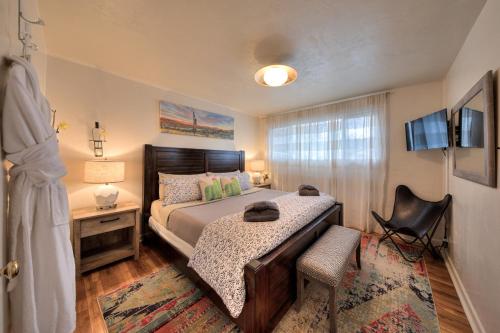 a bedroom with a bed and a desk and a chair at Desert Gardens #1 in Moab