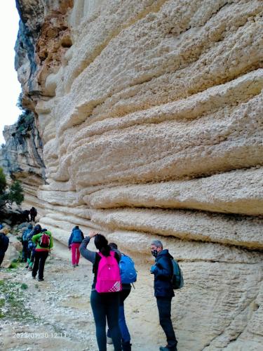 a group of people walking up a rock wall at SARDEGNA DEL NORD - BELLISSIMA CASA CON TERRAZZA - INTERNET Wifi in Laerru