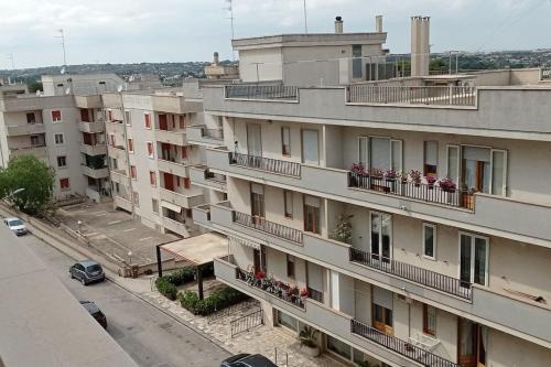 un edificio de apartamentos con balcones en una calle de la ciudad en Appartamento Terrazza Bella Vista, en Cisternino