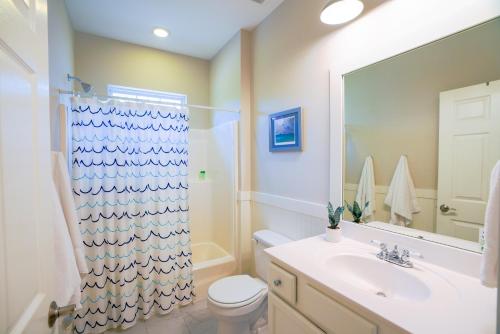 a bathroom with a sink and a toilet and a shower at Ocean Antics - Close to the Beach and minutes to Seaside along 30A in Santa Rosa Beach
