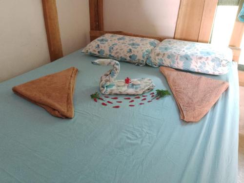 a blue bed with a toy snake on top of it at Cabinas jugle jause in Drake